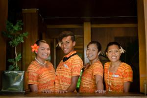 a group of four young men posing for a picture at Namale All Inclusive Resort & Spa in Savusavu