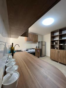 a kitchen with a long wooden counter top in a room at Hotel Khulo lnn in Khulo