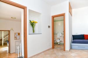 a room with a mirror and a vase of flowers at Moon Smile in Massa Lubrense