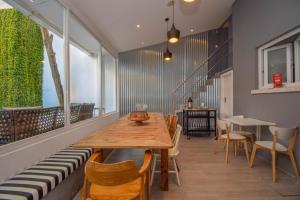 a dining room with a wooden table and chairs at The Lx Hill in Lisbon
