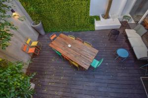 an overhead view of a wooden table and chairs at The Lx Hill in Lisbon