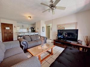 a living room with couches and a flat screen tv at Laguna La Crete 216, Beach Front Holiday Apartment in Margate