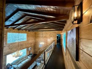 a hallway of a house with a couch and a staircase at Creekfront Lodge: Brand new! in Pigeon Forge