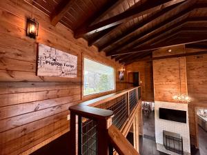 a room with a staircase in a wooden cabin at Creekfront Lodge: Brand new! in Pigeon Forge