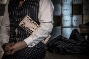 a man in a suit with a money at Hotel Gotham in Manchester