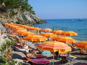 a bunch of orange umbrellas on a beach at Villino Cetarola in Sperlonga