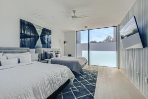 um quarto com 2 camas e uma grande janela em Modern House Downtown View with Pool & Hot Tub em Austin
