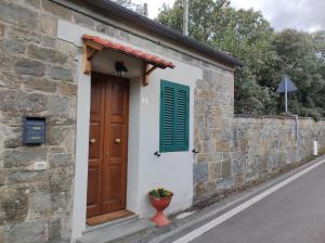 a brick building with a door and a window and a flower pot at La piccola Posta di Cortona in Cortona
