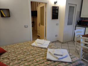 a hotel room with a bed with towels on it at La piccola Posta di Cortona in Cortona