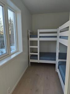 a room with two bunk beds and a window at Torghatten bnb in Brønnøysund