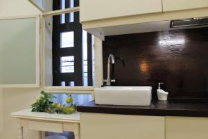 a kitchen counter with a sink and a window at SmartTrip in Seville