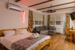 a bedroom with a bed and a living room at Apartments PIT Zdole in Kozje