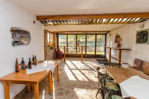 a living room with tables and chairs and windows at Apartments PIT Zdole in Kozje
