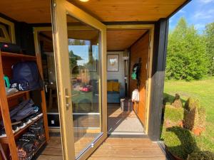 an open door of a tiny house with a porch at Printsu resdents in Eametsa