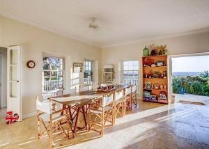 a large kitchen with a wooden table and chairs at Buccaneer Hill Main House home in Governorʼs Harbour