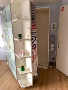 a white book shelf in a room at Sunny studio with seaview in Knokke-Heist +12 photos