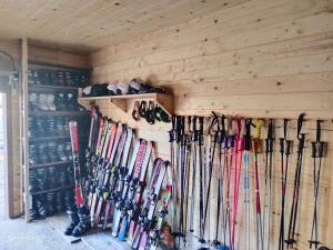 a bunch of skis are lined up against a wall at Нота Карпат in Skole