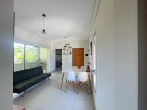 a living room with a couch and a table and chairs at Departamento Moderno La Plata, Plaza España in La Plata