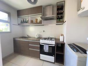 a small kitchen with a stove and a sink at Departamento Moderno La Plata, Plaza España in La Plata +16 photos