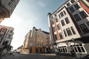 a group of buildings on a city street at Bheaven I Golden Wave Premium Apartment in Bremerhaven