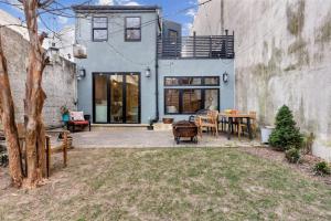 フィラデルフィアにあるDesigner 3 BR Townhome with Beautiful Backyardの建物の前にパティオ(テーブル、椅子付)