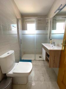 a bathroom with a toilet and a shower and a sink at Mazarron Beach apartment in Mazarrón