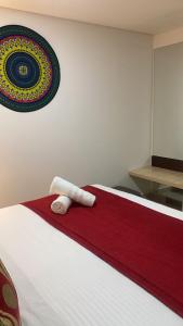 Un dormitorio con una cama con una toalla. en Hotel Bogota Resort, en Bogotá