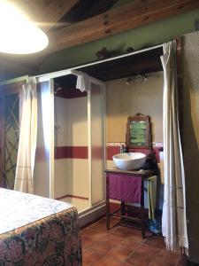 een slaapkamer met een wastafel en een spiegel op een tafel bij Apartamentos Lobiche in Navafría