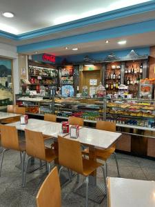 ein Restaurant mit Tischen und Stühlen und eine Bäckerei in der Unterkunft Copacabana Residencial in Costa da Caparica