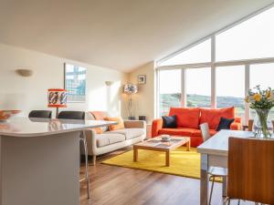 a living room with a couch and a table at 10 Oceans Edge in Kingsbridge