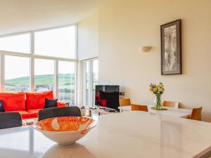 a living room with a table with a bowl on it at 10 Oceans Edge in Kingsbridge