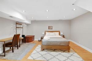 a bedroom with a bed and a desk and a table at Society Hill 4 Bedroom with Garage Parking in Philadelphia