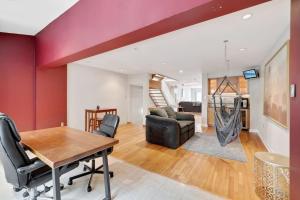 a dining room and living room with a red wall at Society Hill 4 Bedroom with Garage Parking in Philadelphia