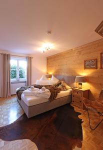 a bedroom with two beds and a desk and a window at 'Chalet-Style' ruhige & zentrale 3-Raum-Suite direkt am Kurpark in Oberstdorf