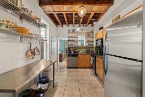 a large kitchen with a stainless steel refrigerator at Fairmount Neighborhood Gem in Philadelphia