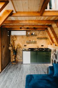 a kitchen with green cabinets and a counter top at SezBungalov in Ardeşen
