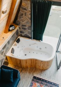 a jacuzzi tub in a room with a stone wall at SezBungalov in Ardeşen