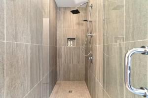 a shower with a glass door in a bathroom at Luxurious Million Dollar Penthouse with Elevator and Parking in Philadelphia