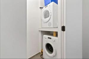 a washing machine and a washer in a kitchen at Luxurious Million Dollar Penthouse with Elevator and Parking in Philadelphia