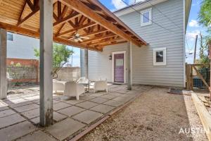 a patio with a wooden pergola and chairs at Enjoy DT In A Newly Renovated Home Covered Patio in Austin