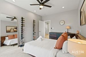 a bedroom with a bed and a ceiling fan at Enjoy DT Newly Renovated & Patio and Free Swim Club by Austin Vacay in Austin +30 photos