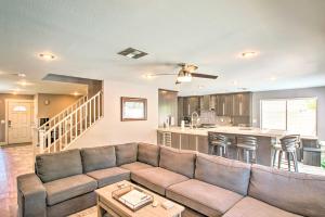 a living room with a couch and a kitchen at Modern Phoenix Haven with Private Pool and Patio! in Phoenix