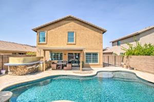 a swimming pool in front of a house at Modern Phoenix Haven with Private Pool and Patio! in Phoenix