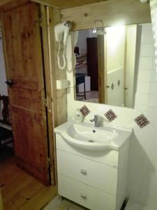 a bathroom with a sink and a mirror at B&B Le Finestre Su Via Cavour in Sassari