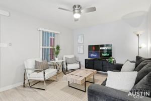 a living room with a couch and a tv at All the Essentials For You and Your Pet in Hyde Park in Austin