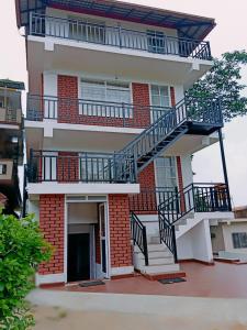 a building with a staircase on the side of it at SERENITY GREENS in Madikeri