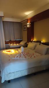 a bedroom with a large white bed with lights on it at Port Dickson Private Water Chalet in Port Dickson