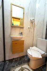 a bathroom with a sink and a toilet and a mirror at THE LITTLE PRINCE BOUTIQUE HOTEL in Antalya
