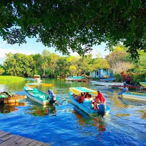 een groep mensen in boten op een rivier bij Cabañas Ixaya in Catemaco