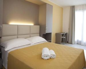 Postel nebo postele na pokoji v ubytování Hotel Bella Lazise